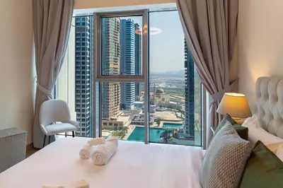 a hotel room with a bed and a large window at MBL Lake VIEW 1 BR in Dubai