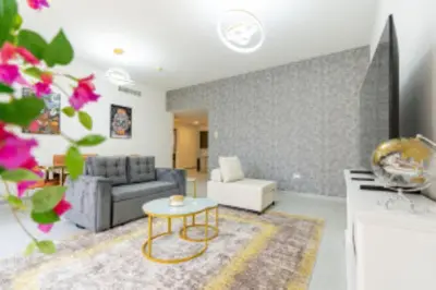 a living room with a couch and a table at Nasma Luxury Stays - Jacuzzi Dreams 1 BR in Jumeirah in Dubai