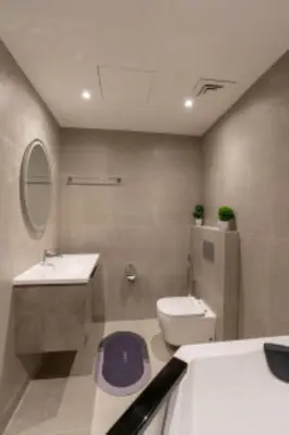 a bathroom with a toilet and a sink and a mirror at Nasma Luxury Stays - Jacuzzi Dreams 1 BR in Jumeirah in Dubai