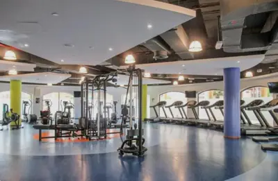 a gym with a lot of treadmills and machines at Nasma Luxury Stays - Jacuzzi Dreams 1 BR in Jumeirah in Dubai