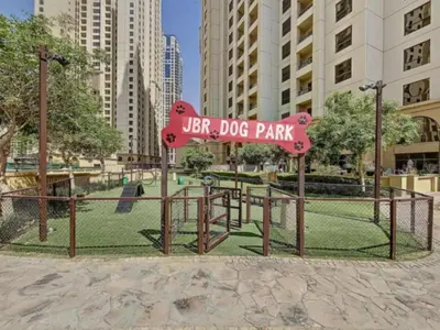 a park with a sign that reads ufc dog park at Nasma Luxury Stays - Jacuzzi Dreams 1 BR in Jumeirah in Dubai
