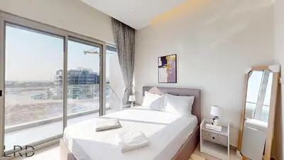 a bedroom with a white bed and a large window at Chic & Cozy 1BR in Centurion Onyx in Dubai