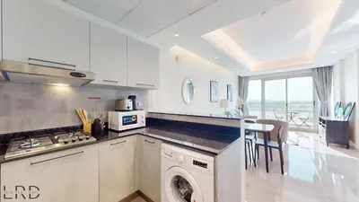 a kitchen with a washer and a dishwasher in it at Chic & Cozy 1BR in Centurion Onyx in Dubai