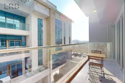 a balcony with a view of a building at Elegant and Modern 1BR Apartment in Dubai
