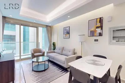 a living room with a couch and a table at Elegant and Modern 1BR Apartment in Dubai