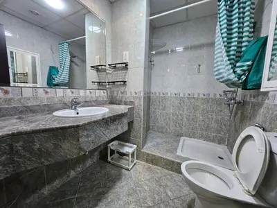 a bathroom with a toilet and a sink at Budget Spacious Room Heart of marina in Dubai