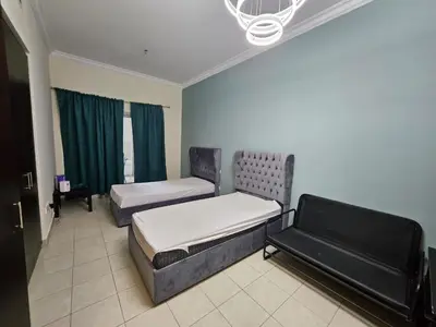 a room with two beds and a couch at Budget Spacious Room Heart of marina in Dubai