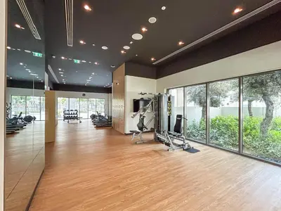 a gym with treadmills and exercise equipment in a building at Lux Creek Home with Burj View steps from the Lagoon in Dubai