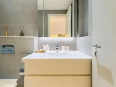 a bathroom with a sink and a mirror at TRPS - Ahad Residences, Business Bay - Full Burj Khalifa View - Modern Furnished Studio in Dubai