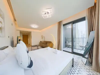 a hotel room with two beds and a balcony at TRPS - Ahad Residences, Business Bay - Full Burj Khalifa View - Modern Furnished Studio in Dubai