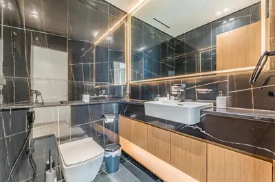 a bathroom with a toilet and a sink at Sky Level 1BR with Lake View and City Glimpse, Close Proximity to Community Park, Binghatti Onyx, Jumeirah Village Circle by Deluxe Holiday Homes in Dubai