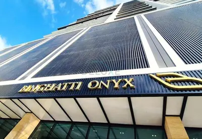 a view of the front of a high rise building at Sky Level 1BR with Lake View and City Glimpse, Close Proximity to Community Park, Binghatti Onyx, Jumeirah Village Circle by Deluxe Holiday Homes in Dubai