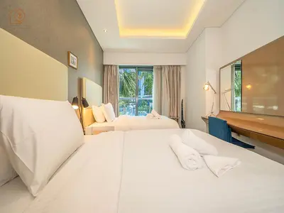 a hotel room with two beds and a desk at Elegant 2 Bedroom Apartment with Pool Views at Business Bay 211DPA-2 in Dubai