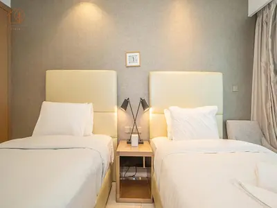 a hotel room with two beds and a table at Elegant 2 Bedroom Apartment with Pool Views at Business Bay 211DPA-2 in Dubai