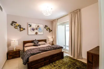 a bedroom with a bed and a window at Spacious 1BR with Balcony in JLT Cluster E in Dubai