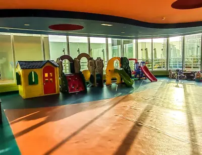 a gym with childrens play equipment in a building at Spacious 1BR with Balcony in JLT Cluster E in Dubai