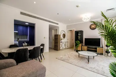 a living room with a table and a dining room at Spacious 1BR with Balcony in JLT Cluster E in Dubai
