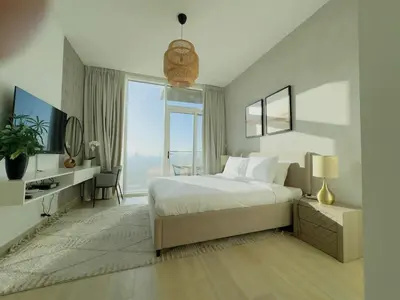 a bedroom with a large bed and a large window at Sky-High Studio Marina Skyline View Bloom Tower in Dubai