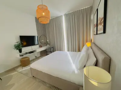 a bedroom with a large bed and a television at Sky-High Studio Marina Skyline View Bloom Tower in Dubai