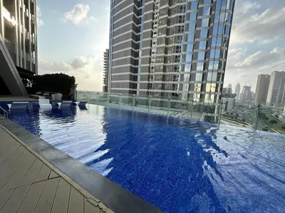 a large swimming pool on the roof of a building at Stylish Studio Bayz Danube Burj Khalifa View Pool in Dubai