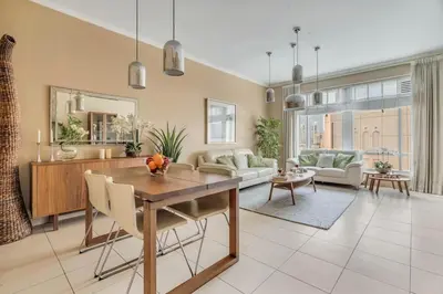 a living room with a table and a couch at DAYF-BVE Large 1BR in Downtown Steps to Dubai Mall in Dubai