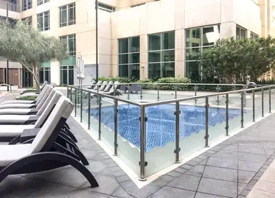 a pool in front of a building with benches at DAYF-BVE Large 1BR in Downtown Steps to Dubai Mall in Dubai