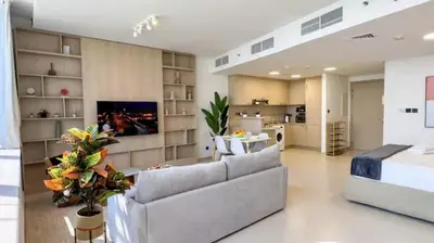 a large living room with a couch and a tv at DAYF-SKG High Floor Studio in Sky Gardens Heart of DIFC in Dubai