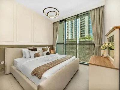 a bedroom with a large bed and a large window at Chic 1BR in Downtown Dubai-Direct access to Dubai Mall in Dubai