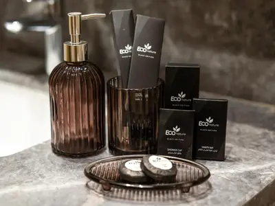 a counter top with a bottle of soap and a plate with a diffuser at Chic 1BR in Downtown Dubai-Direct access to Dubai Mall in Dubai