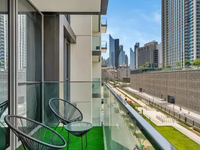 a balcony with chairs and a view of the city at Chic 1BR in Downtown Dubai-Direct access to Dubai Mall in Dubai