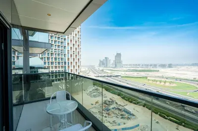 a balcony with a view of a beach and a building at Stylish 2BR in Business Bay Dubai life - Free Pool in Dubai