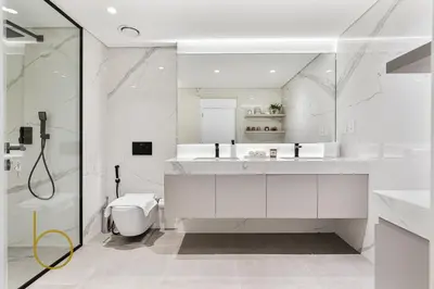 a white bathroom with a shower and a toilet at Bookable - 2 Bedroom Boulevard Central in Dubai