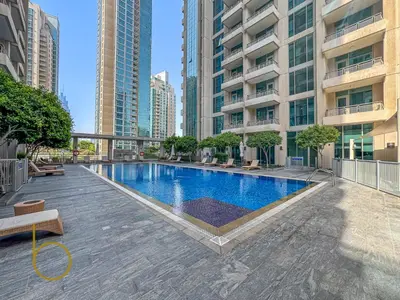 a swimming pool in a city with tall buildings at Bookable - 2 Bedroom Boulevard Central in Dubai
