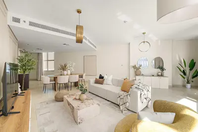 a living room with a couch and a table at Silkhaus Cityscape 2BR in DIFC Prime location in Dubai