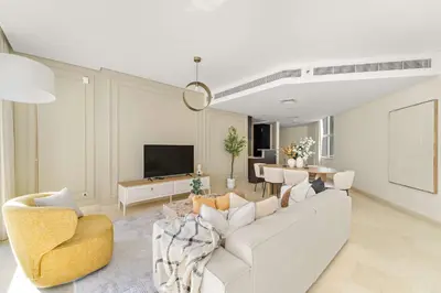 a living room with a white couch and a table at Silkhaus Cityscape 2BR in DIFC Prime location in Dubai