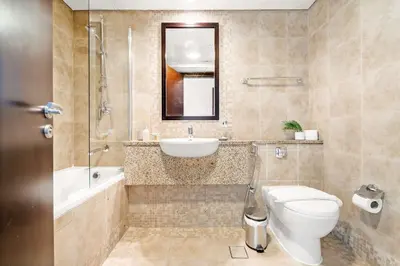 a bathroom with a toilet and a sink and a shower at Silkhaus Premium 2BDR Stay in Sky Gardens DIFC in Dubai