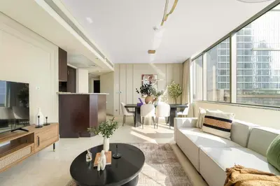 a living room with a couch and a table at Silkhaus Premium 2BDR Stay in Sky Gardens DIFC in Dubai