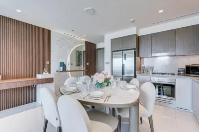 a kitchen and dining room with a table and chairs at Beachfront Bliss 2Bedroom in Grand Bleu in Dubai