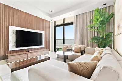 a living room with a large couch and a tv at Nobles tower tiger in Dubai