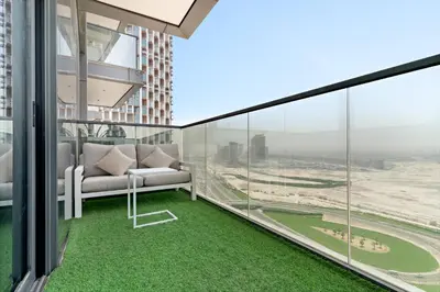 a balcony with a couch and a view of a city at Nobles tower tiger in Dubai