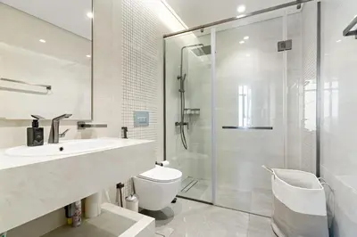 a bathroom with a shower and a toilet and a sink at Nobles tower tiger in Dubai