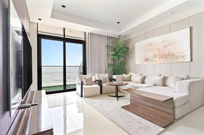 a living room with a white couch and a table at Nobles tower tiger in Dubai