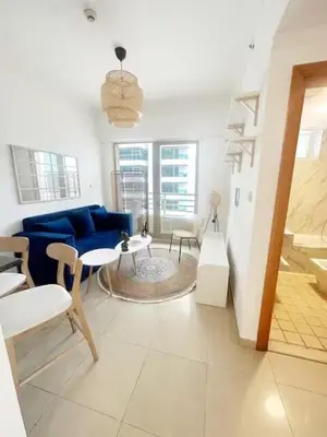 a living room with a blue couch and a table at Luxury 1 BHK in Dubai Marina By dPie Man 1011 in Dubai