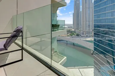 a balcony of a building with a view of a river at Elegant 1B Missoni-Near Burj & Dubai Mall in Dubai