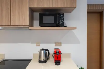 a kitchen with a counter top with a microwave at Elegant 1B Missoni-Near Burj & Dubai Mall in Dubai