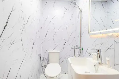 a white bathroom with a toilet and a sink at Luxury 2BR in Dubai Marina Man 405 in Dubai