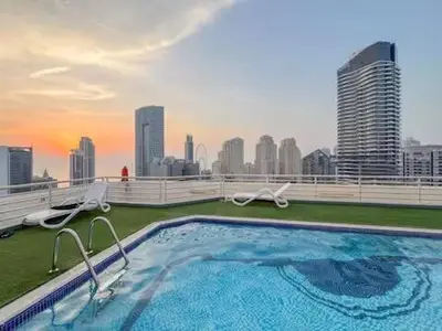 a swimming pool on the roof of a building at Luxury 2BR in Dubai Marina Man 405 in Dubai