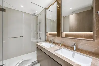 a bathroom with two sinks and a shower at Golden Stays - Luxury Emaar Beachfront 2BR I Sea & Palm Views in Dubai