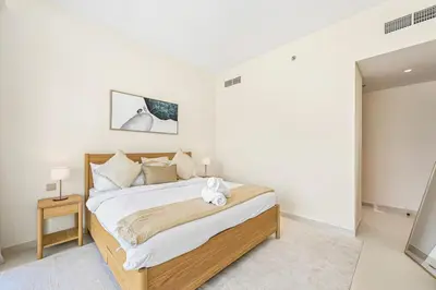 a bedroom with a large bed in a room at Golden Stays - Luxury Emaar Beachfront 2BR I Sea & Palm Views in Dubai