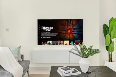 a living room with a movie poster on the wall at Golden Stays - Luxury Emaar Beachfront 2BR I Sea & Palm Views in Dubai